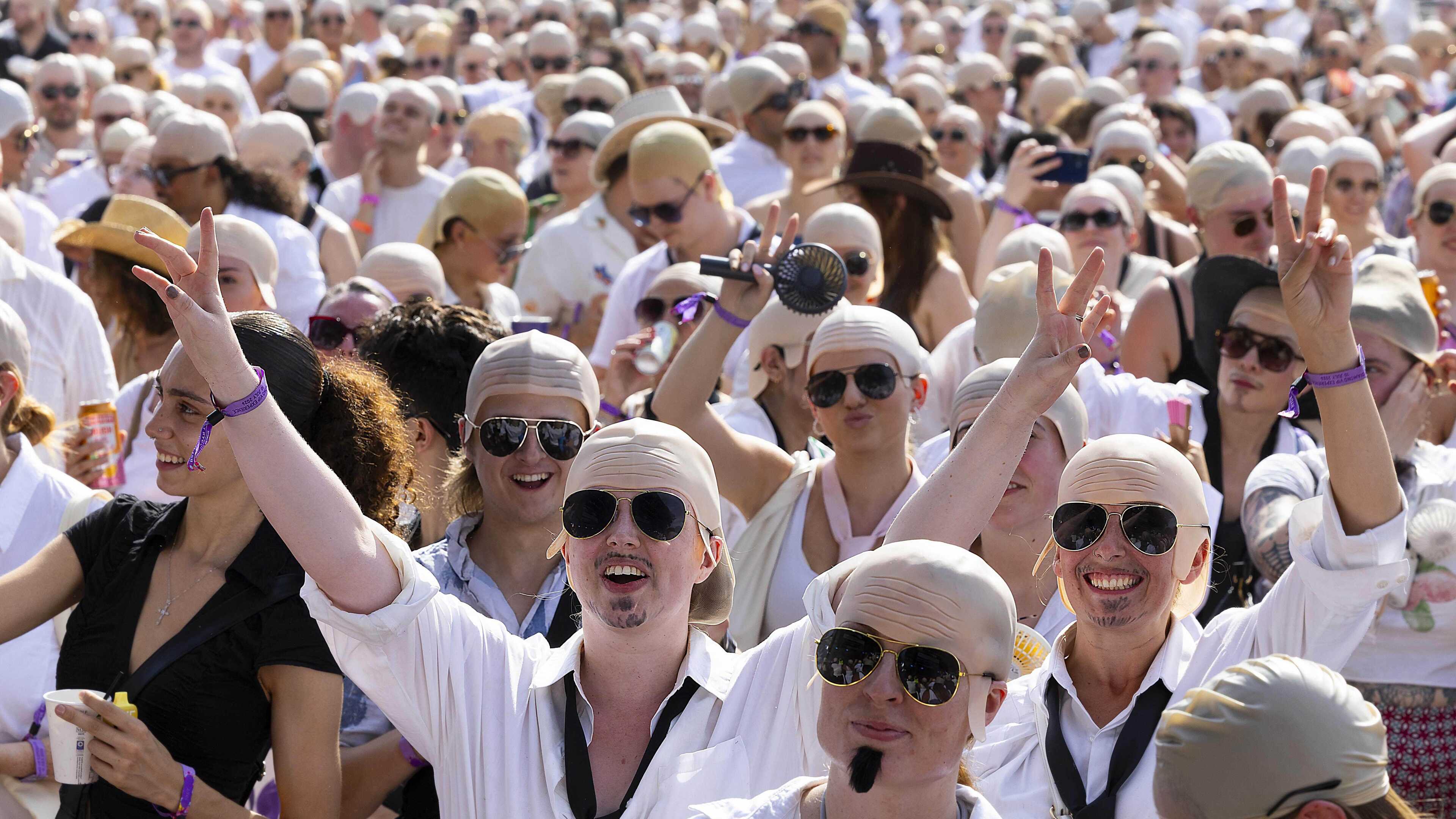 Count begins as Pitbull aims for record gathering of people wearing bald caps