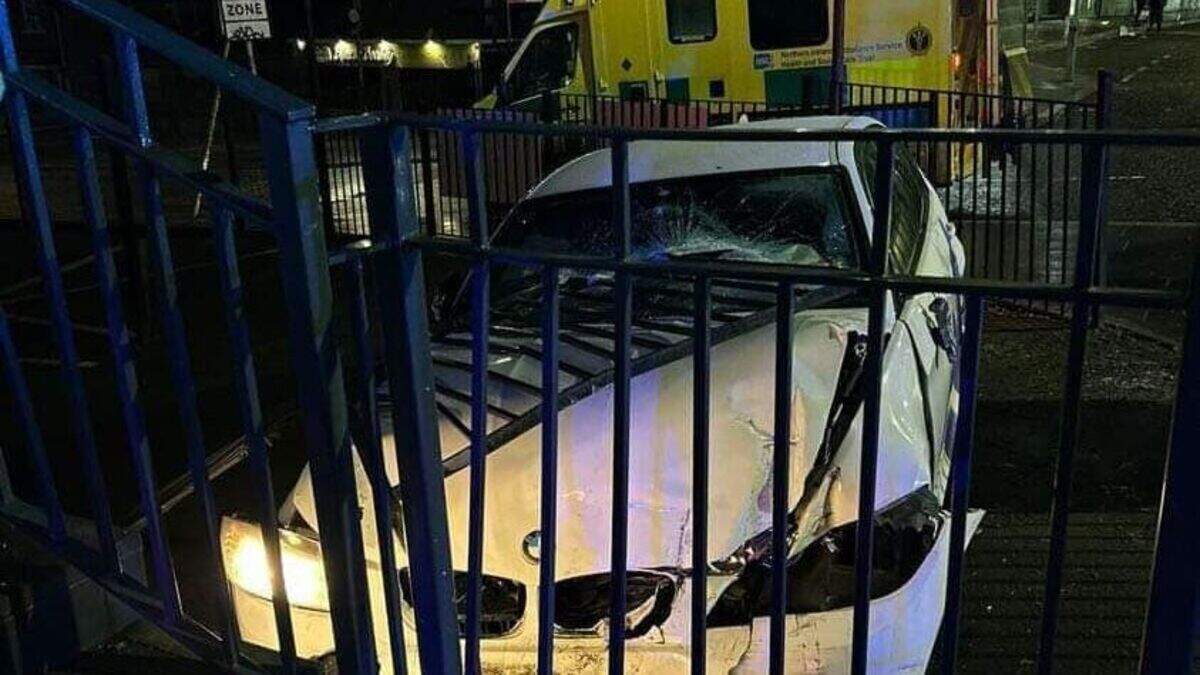 Andersonstown Road: Man arrested after car crashes into fence in west ...