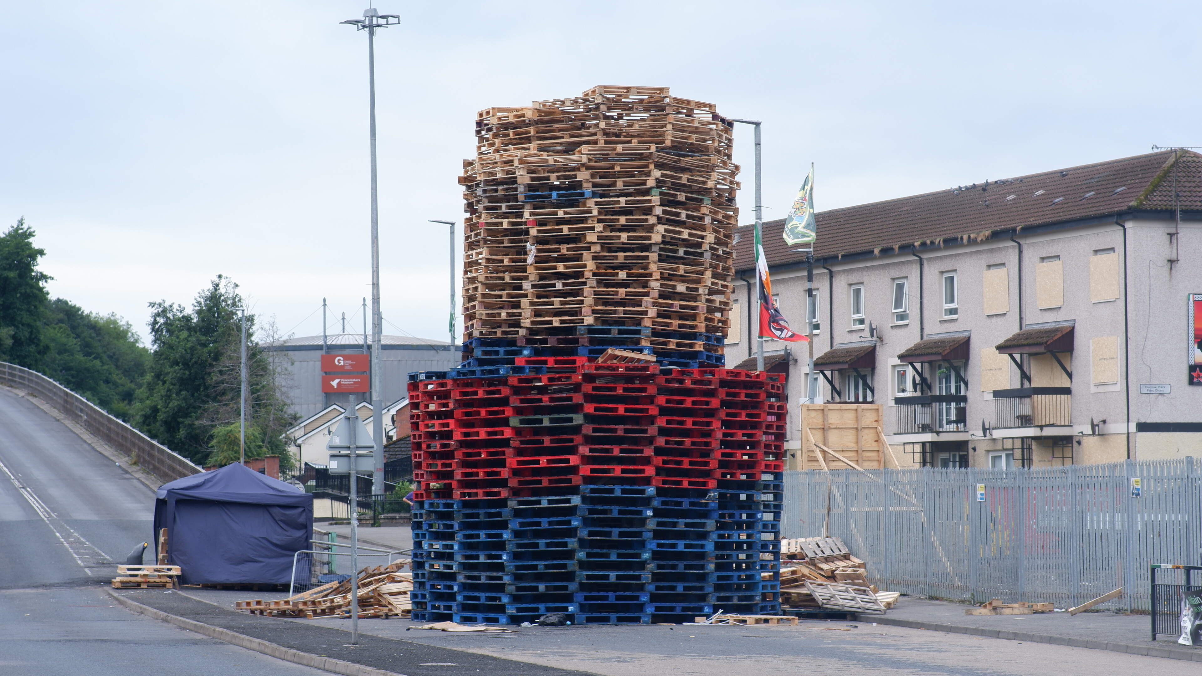 Derry bonfire built in middle of road as windows in nearby flats are boarded up