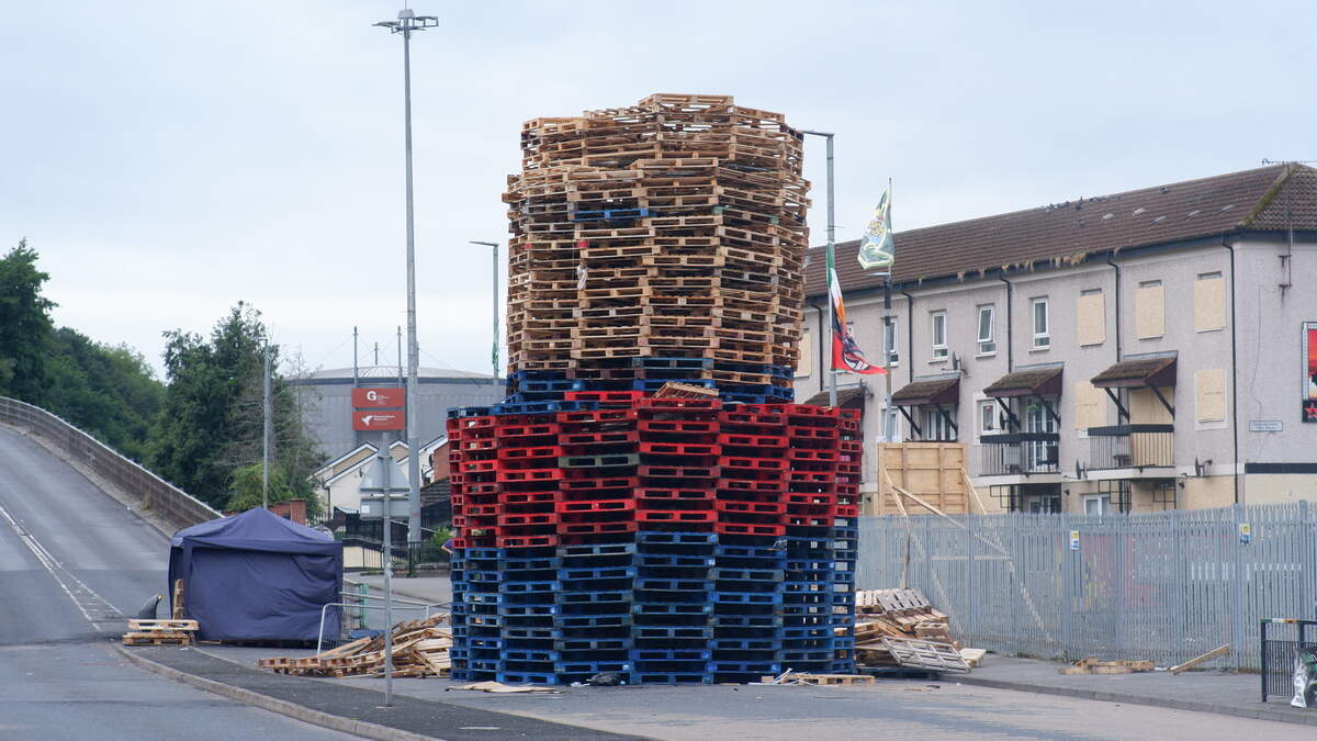 Derry bonfire built in middle of road as windows in nearby flats are boarded up