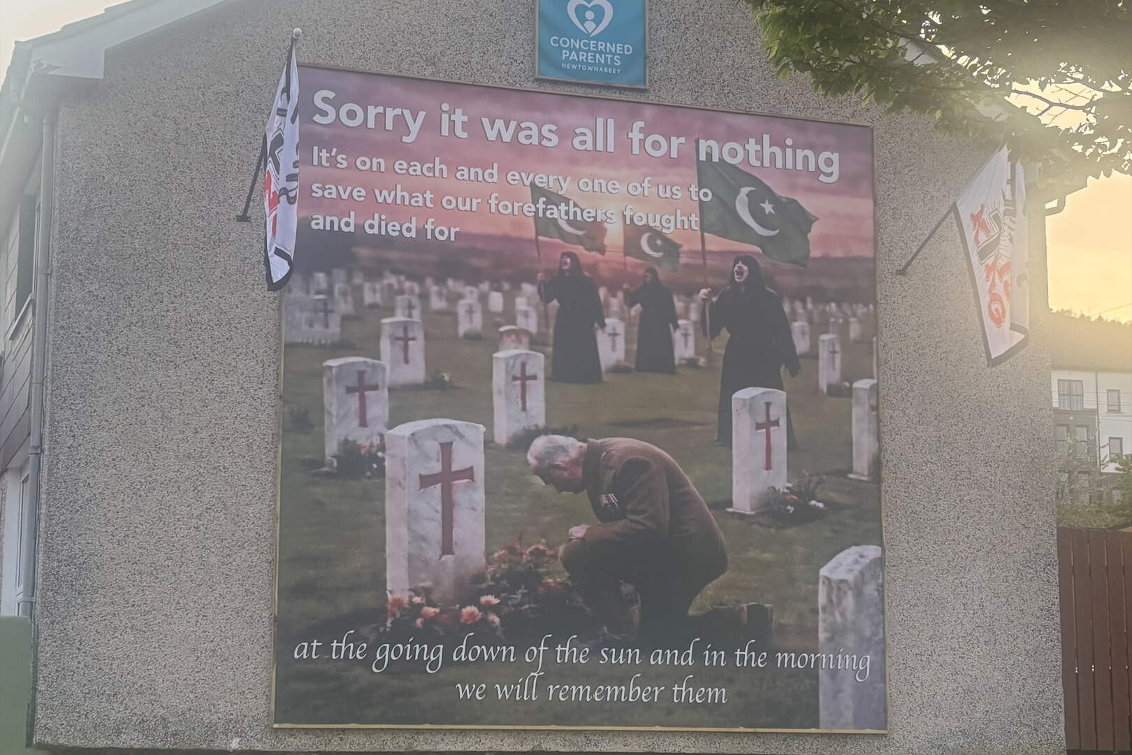Newtownabbey anti-immigration mural: Two men cautioned for offensive ...