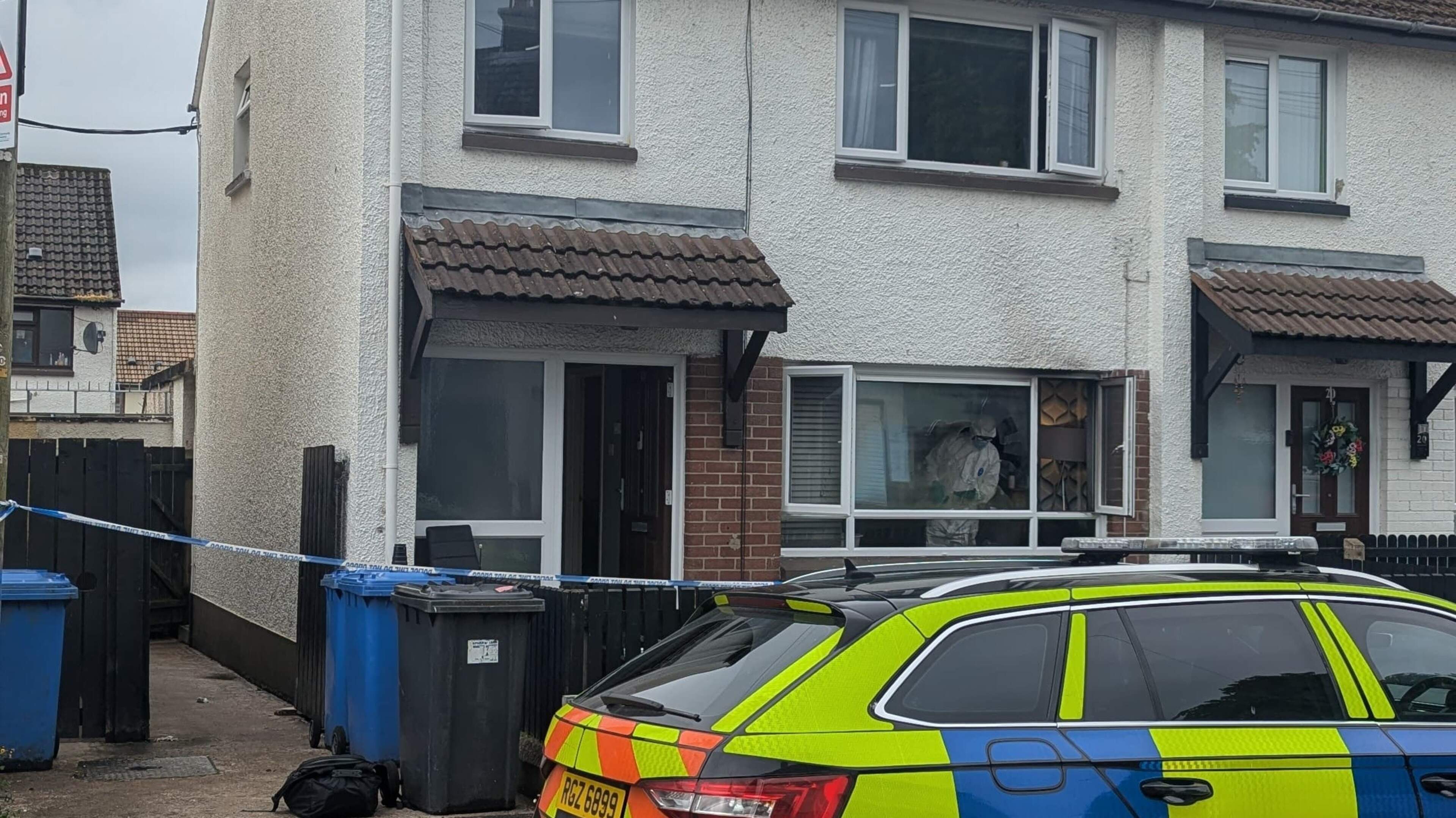 Police and forensic teams at scene of arson attack at Coleraine house