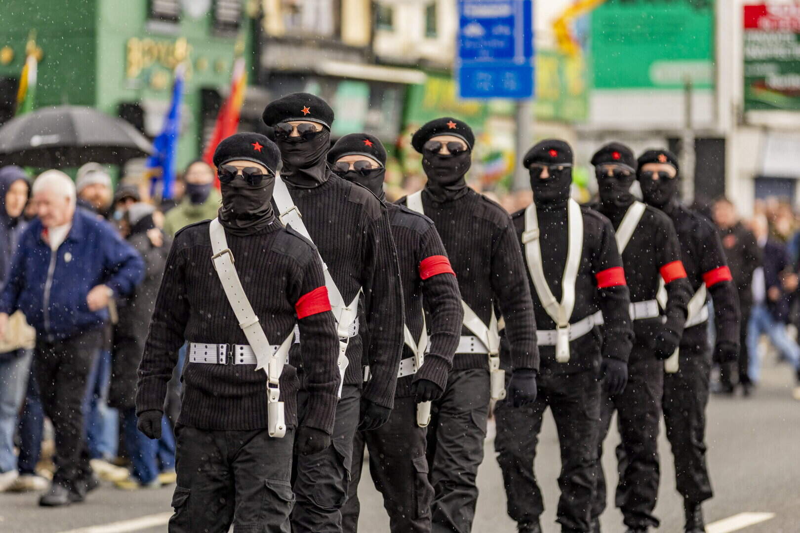 Masked Republican Colour Party Marches Through West Belfast for Easter Commemoration