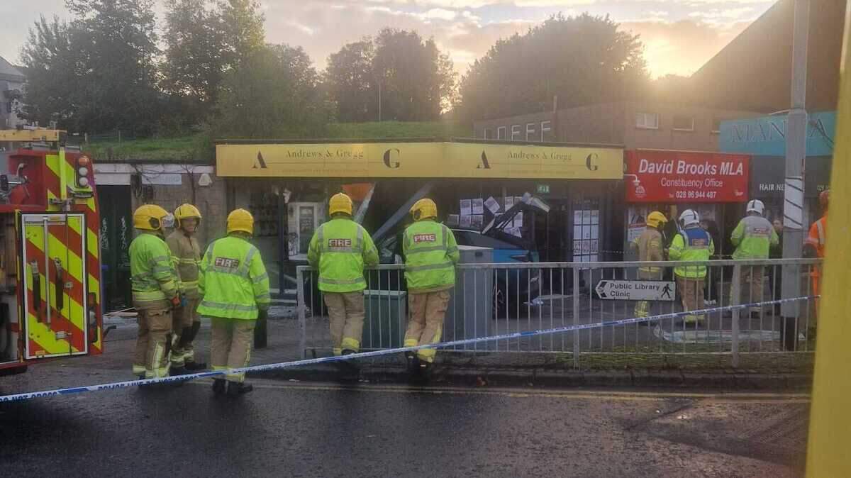 Emergency services at the scene after car crashes into estate agents