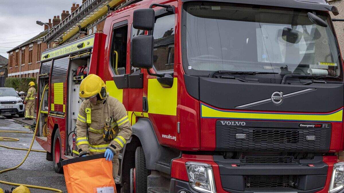 Firefighters at the scene of ongoing house fire in west Belfast ...