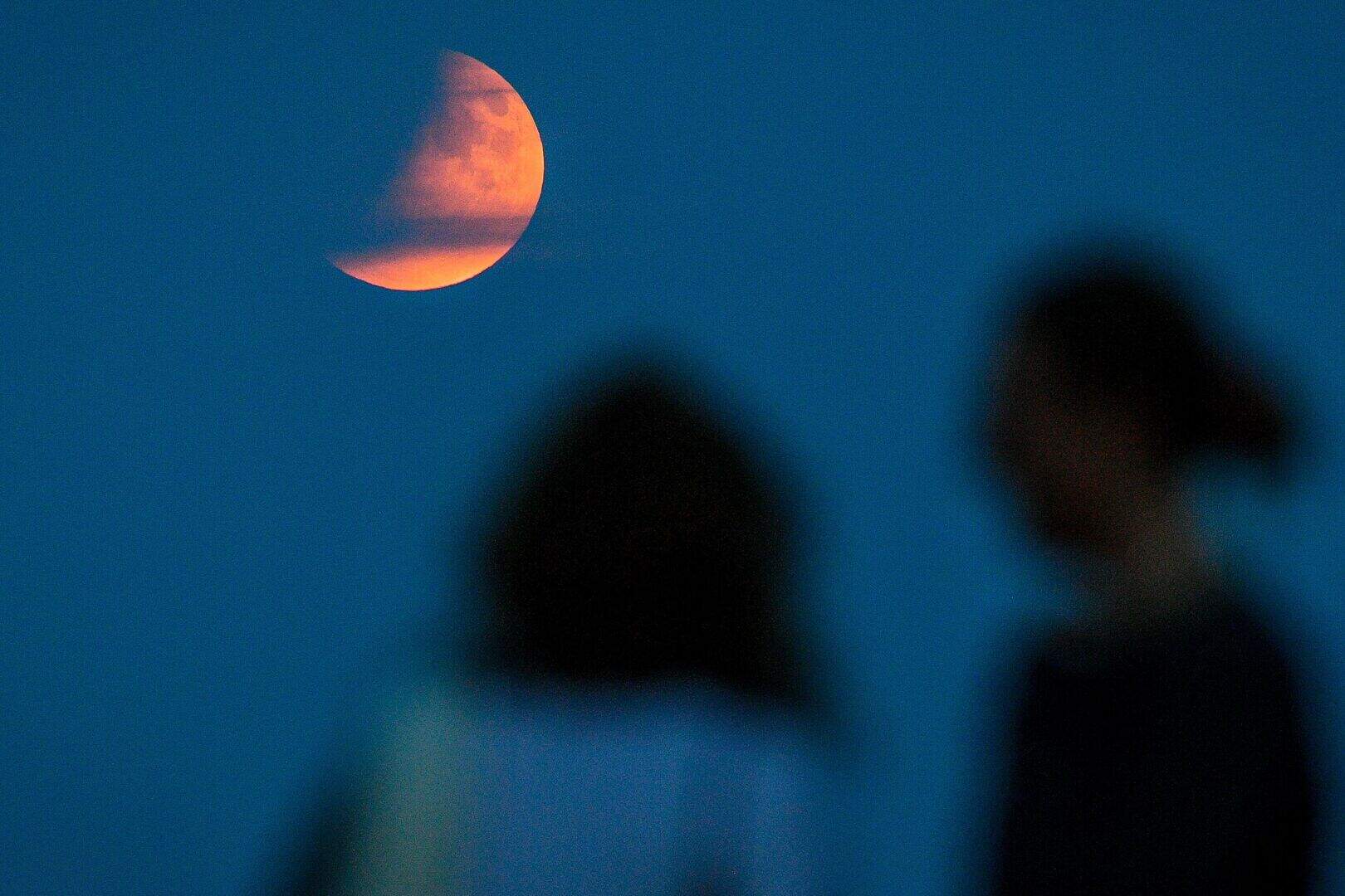 Partial lunar eclipse lights up skies 50 years on from Apollo 11 launch ...