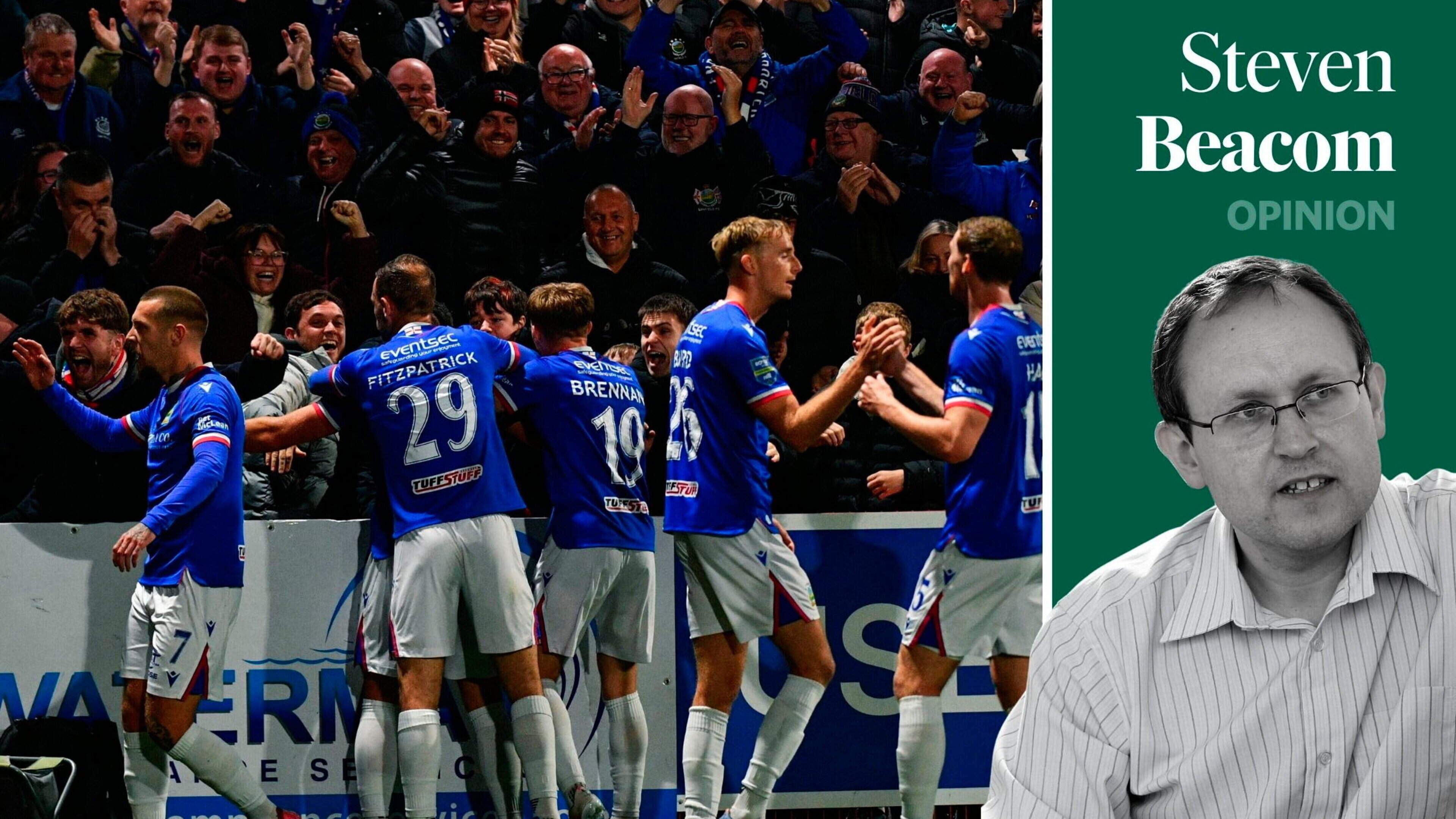 Linfield players celebrate Ethan McGee’s late winner at Inver Park infront of the Blues travelling away support