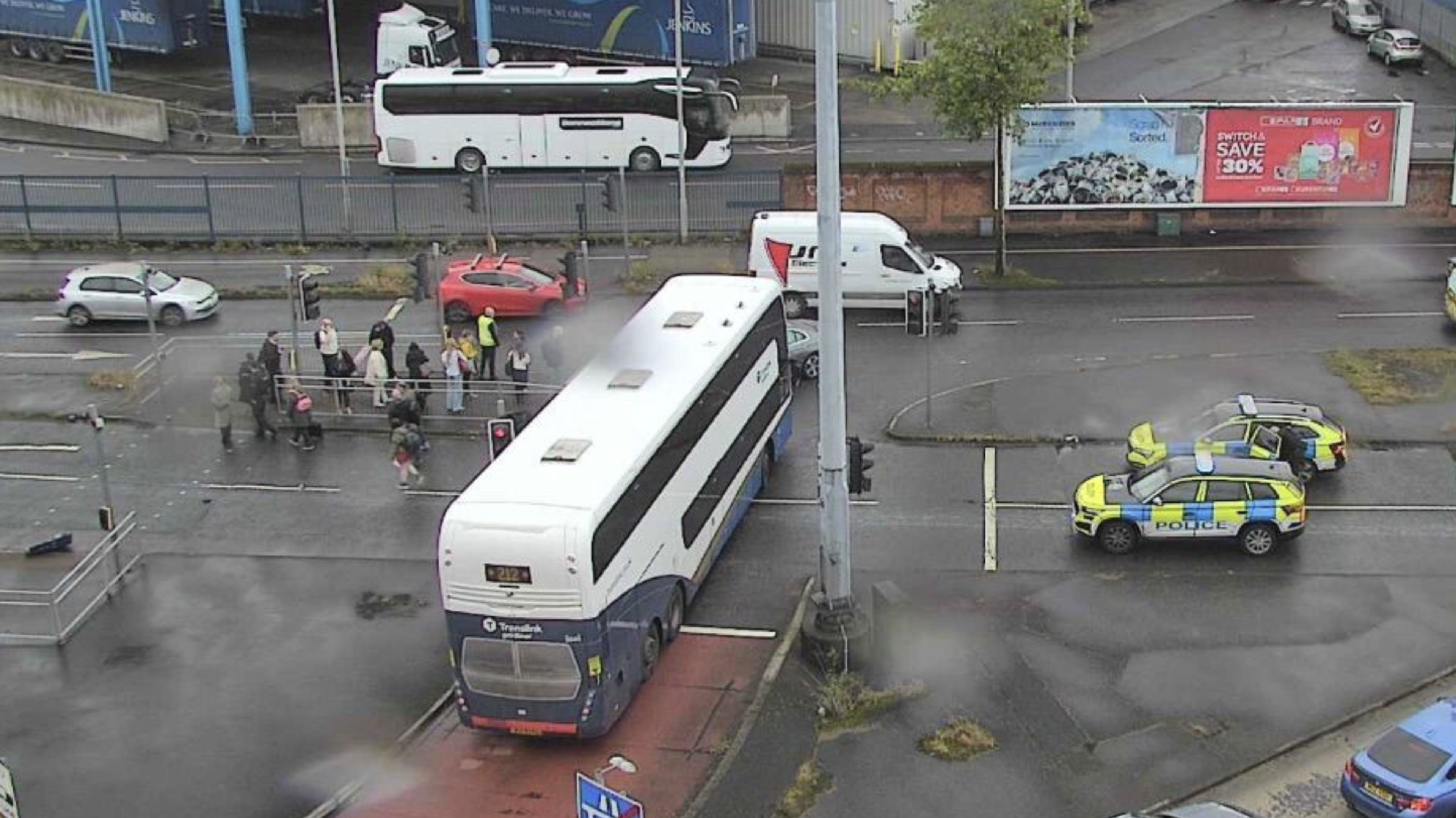 Emergency services at scene of crash involving bus and car in Belfast