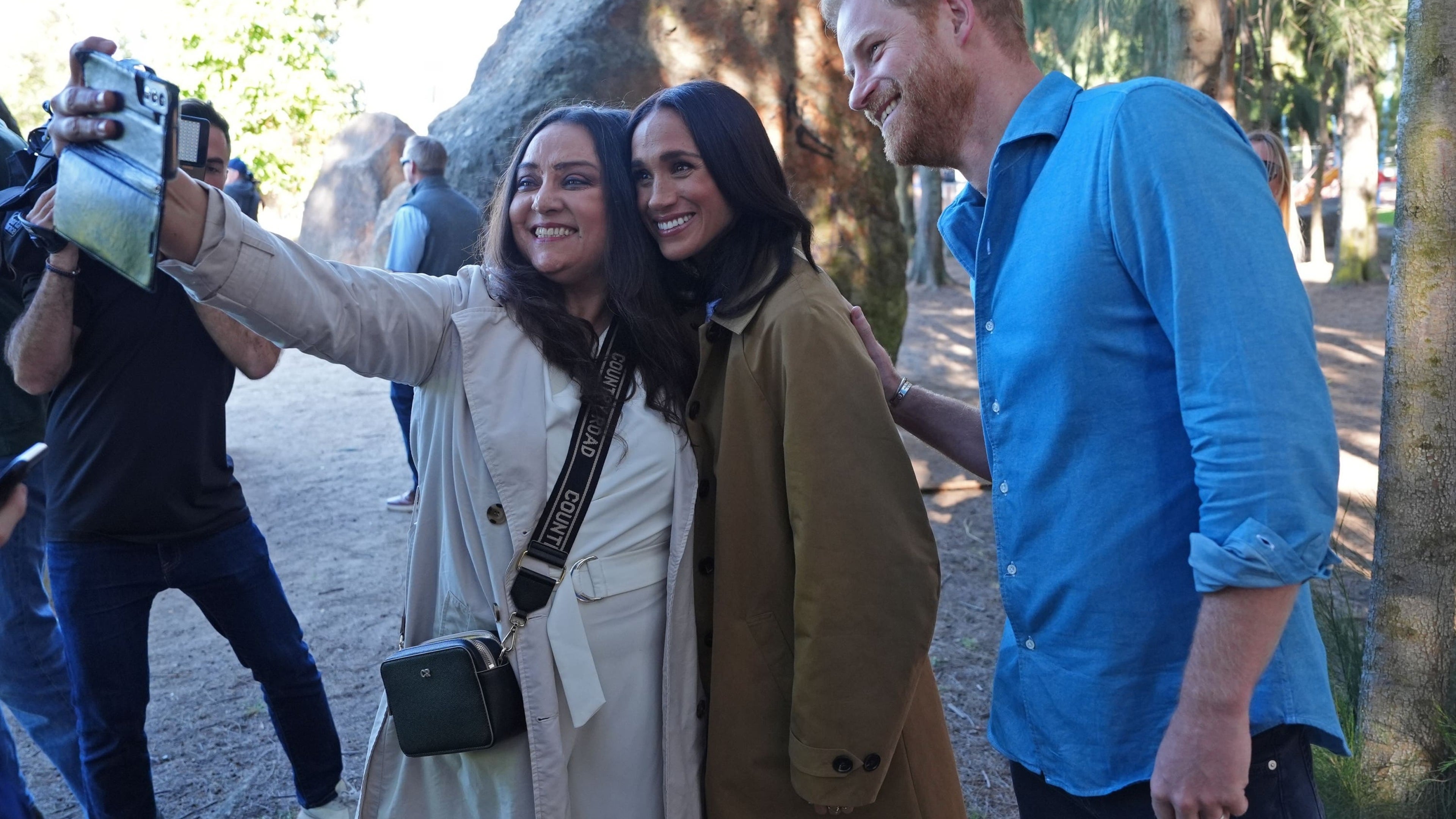Harry and Meghan pose for selfies with public during walking tour