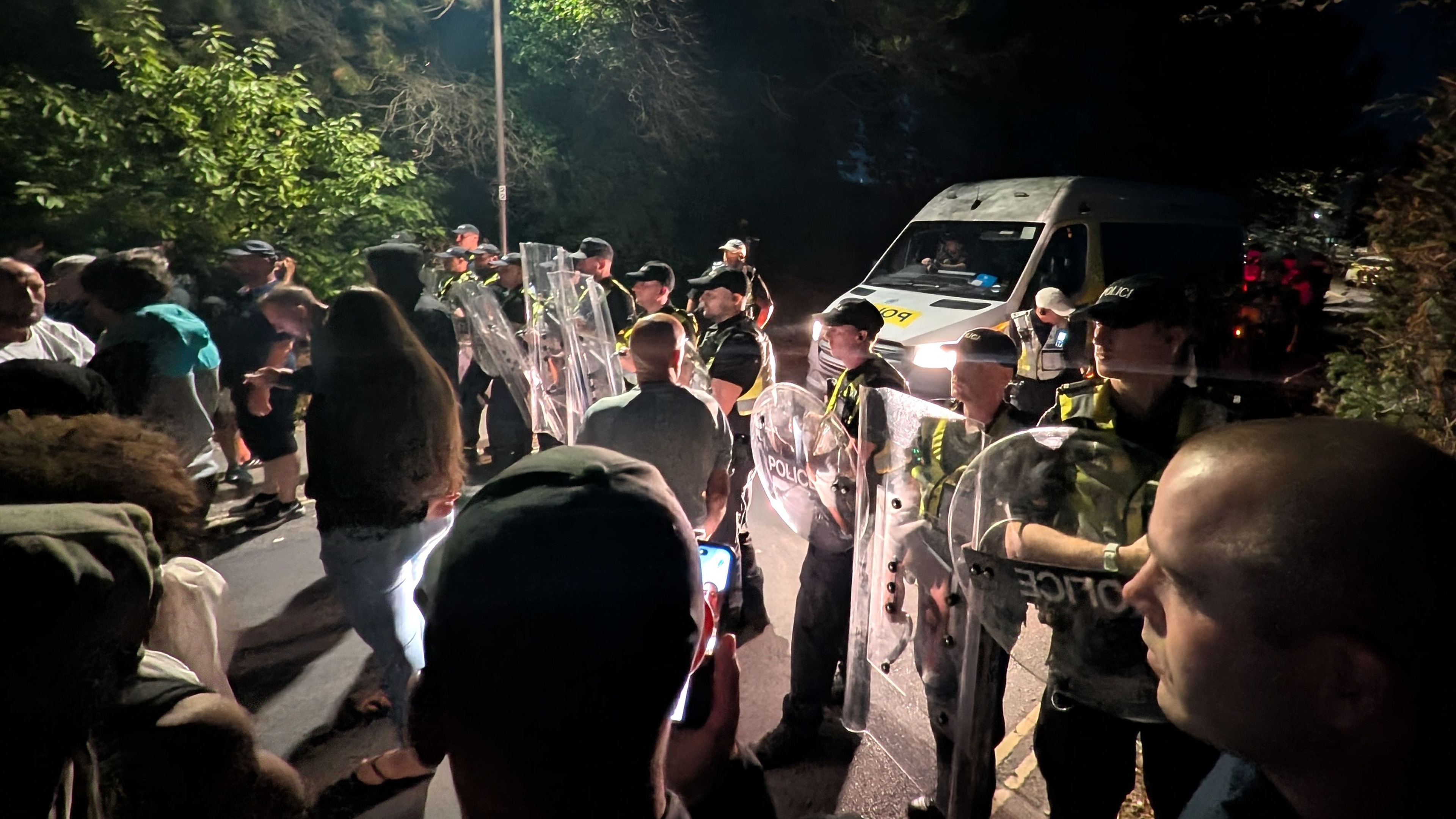 Hundreds of protesters clash with police after migrant boat arrives