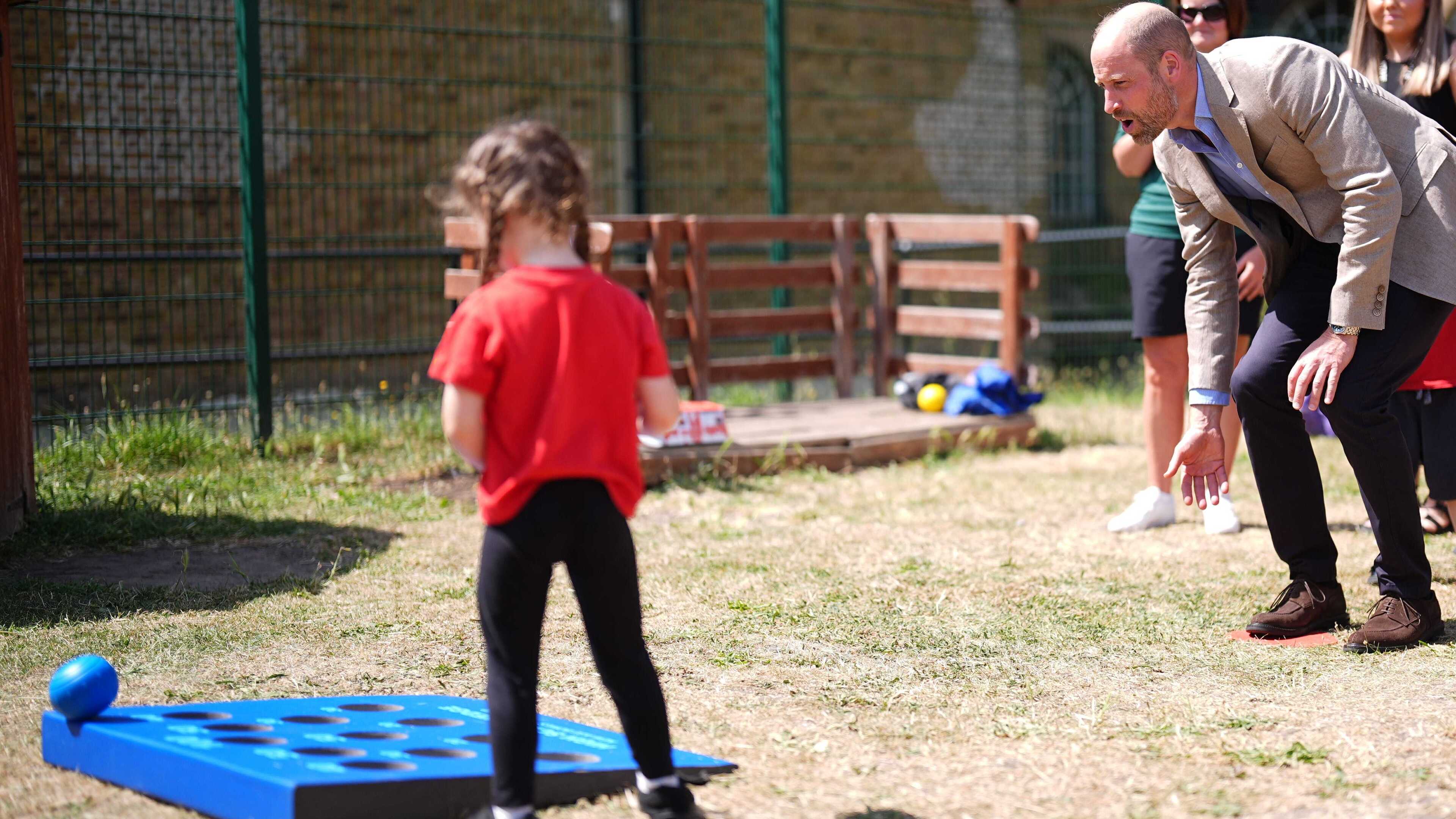 Prince William plays bowls with schoolchildren as Prince Harry begins UK visit
