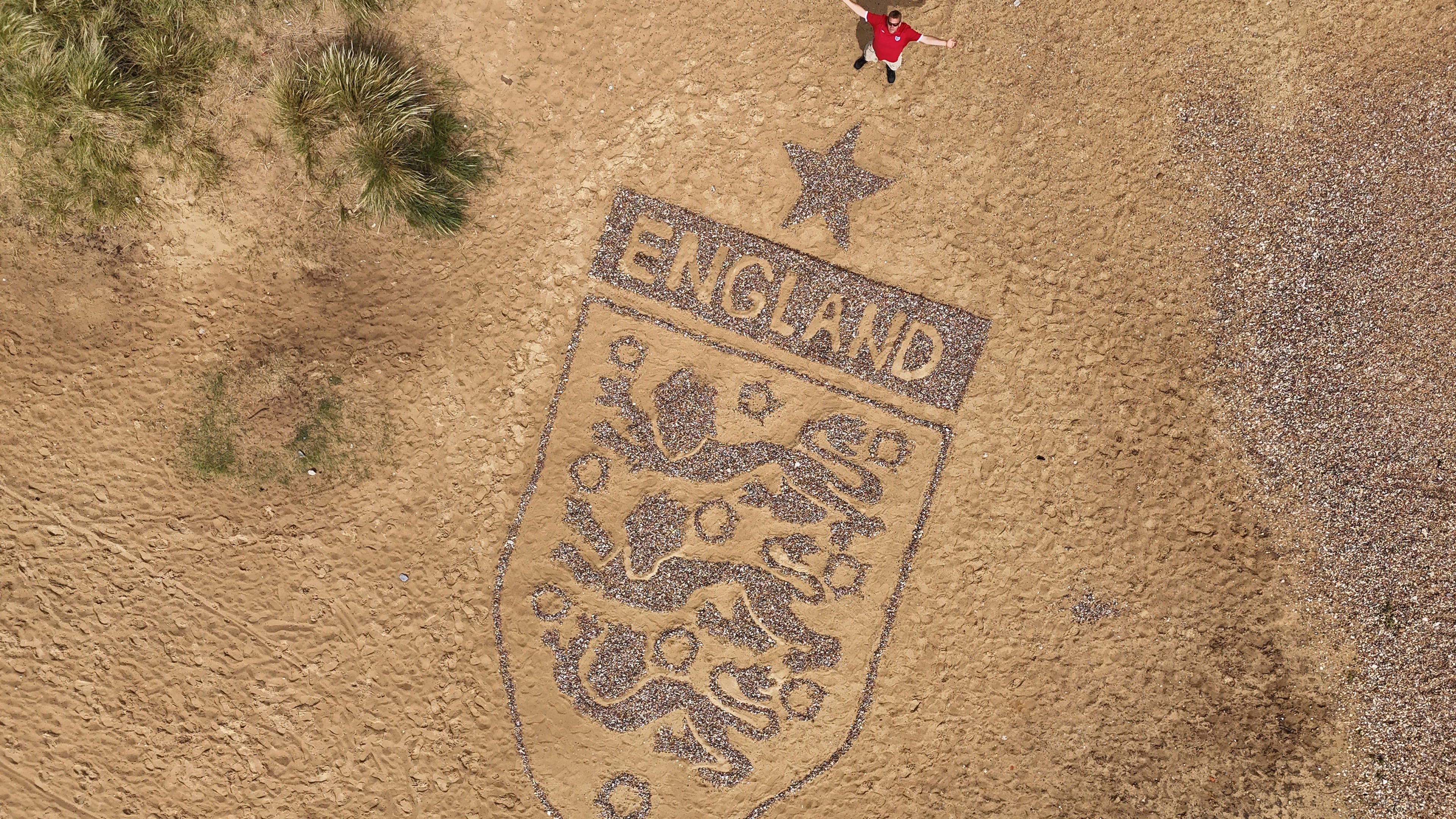 Artist builds giant England ‘Three Lions’ badge on Suffolk beach ahead of World Cup match