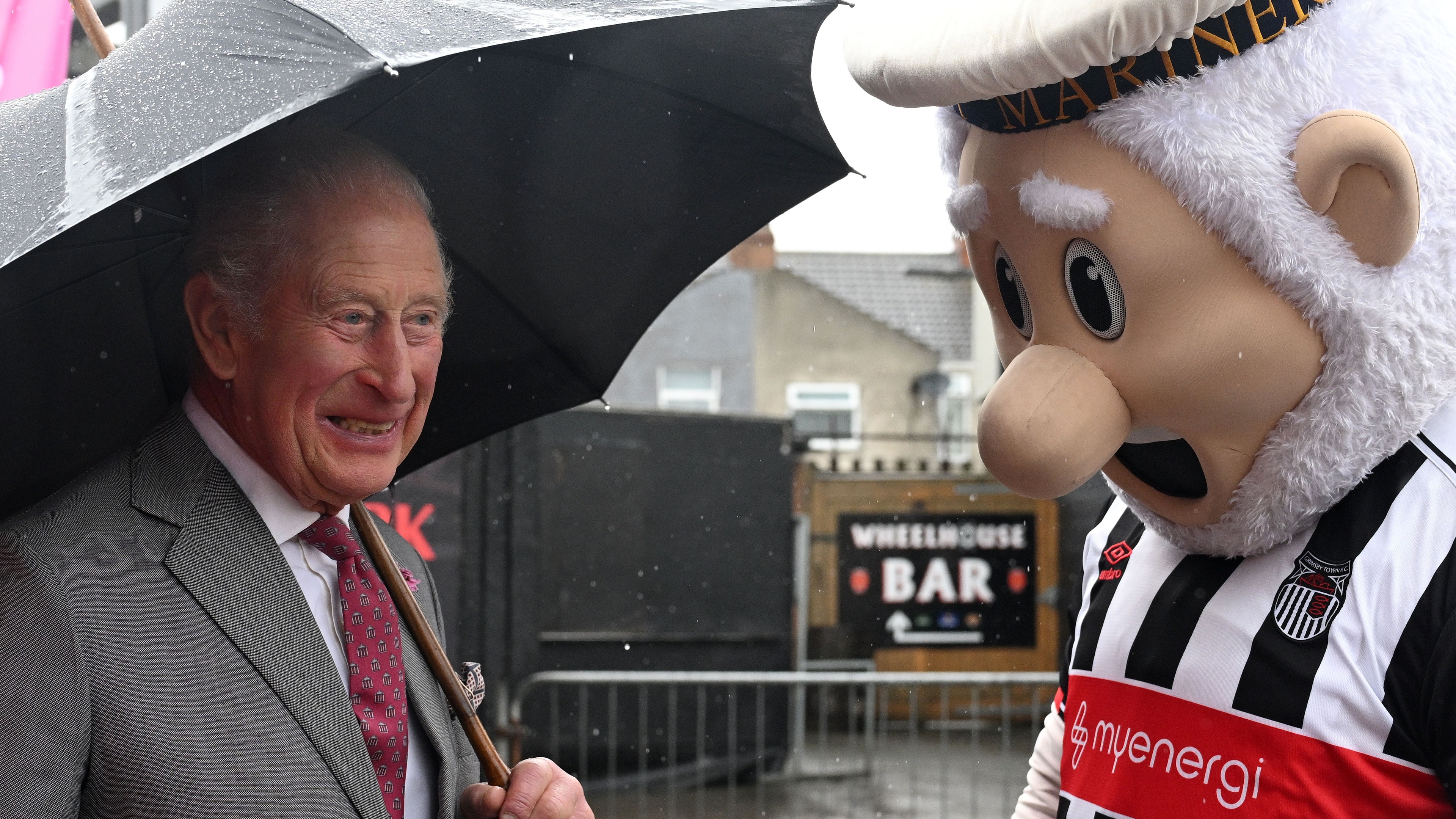 King Charles meets Grimsby Town mascot despite rain