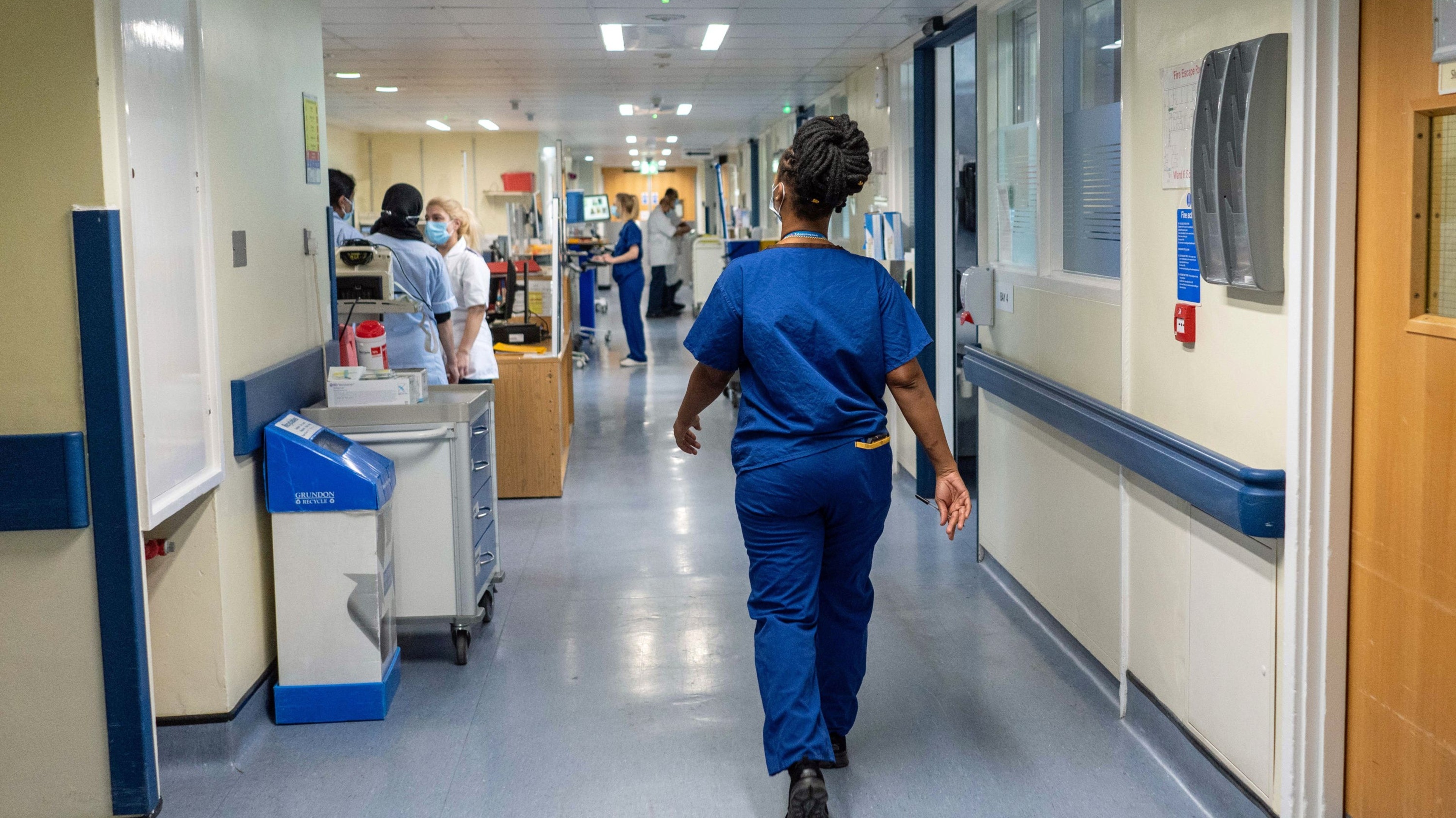 Government reports progress toward NHS waiting-time target, experts say more action needed
