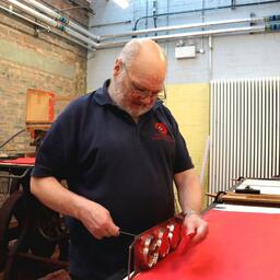 Jock Sloan makes poppies at Lady Haig’s Poppy Factory in Edinburgh (PA)