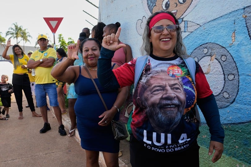 A supporter of President Luiz Inacio Lula da Silva lines up at a polling station in Brasilia (Eraldo Peres/AP)