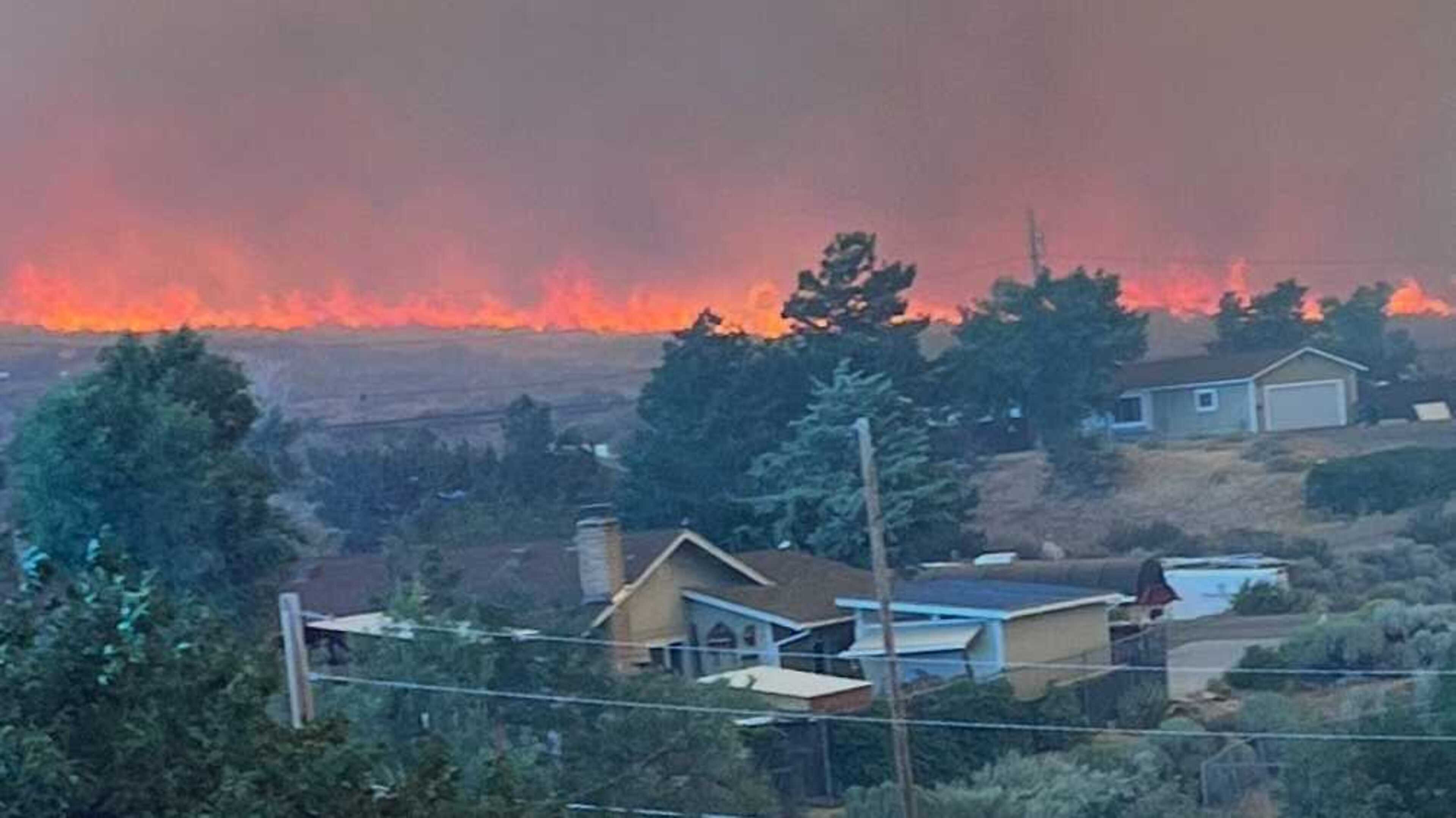 Firefighters work to prevent fast-moving Nevada wildfire from spreading to Reno