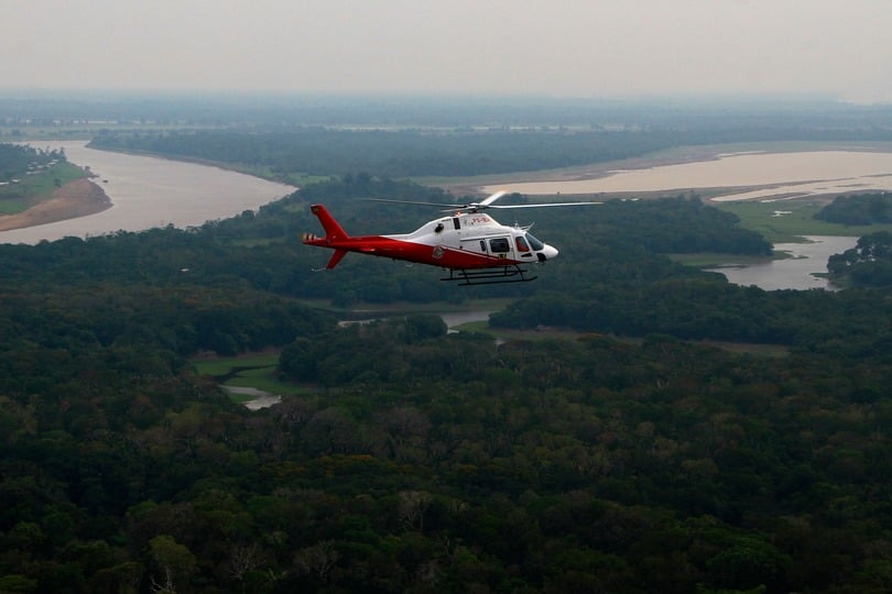 A helicopter from Brazil’s environmental agency flies over an area of the Amazon rainforest (Edmar Barros/AP)