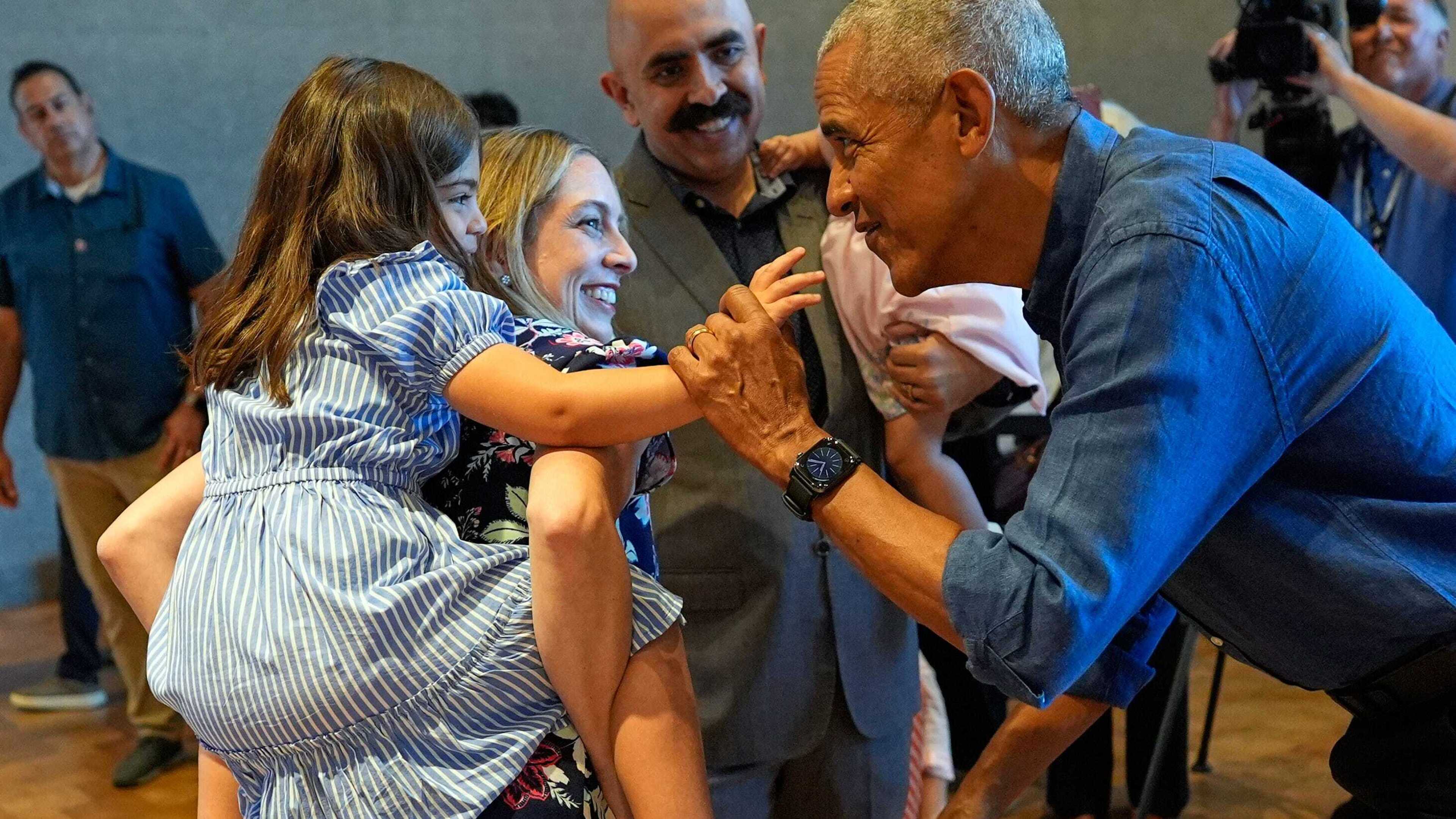 Barack and Michelle Obama greet first visitors at newly opened presidential center