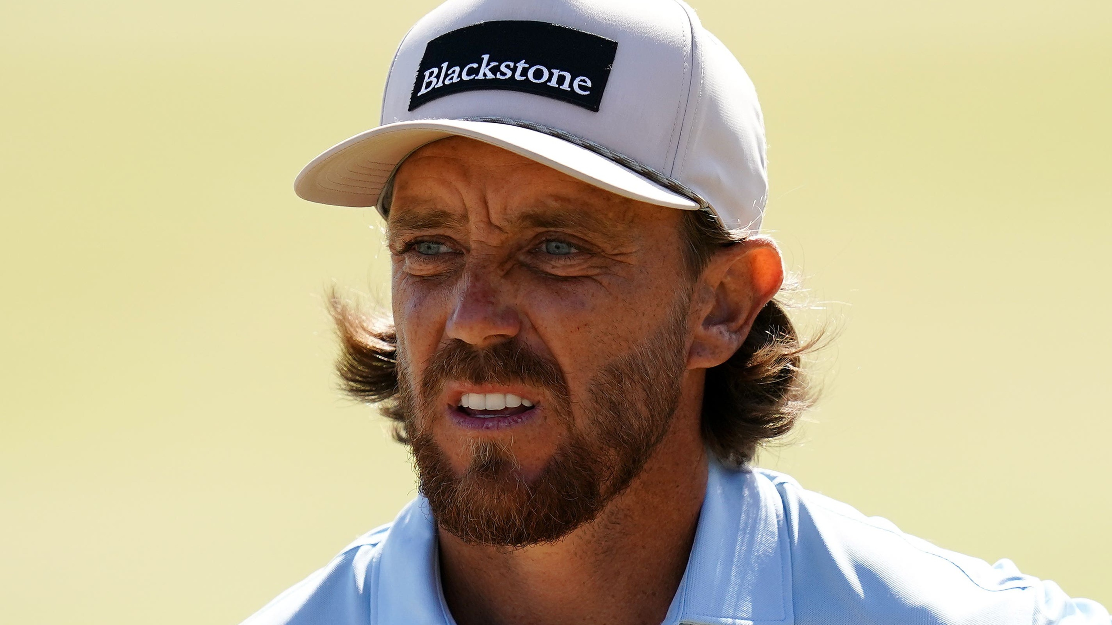 Tommy Fleetwood slips as Cameron Young sets the pace at the home Open